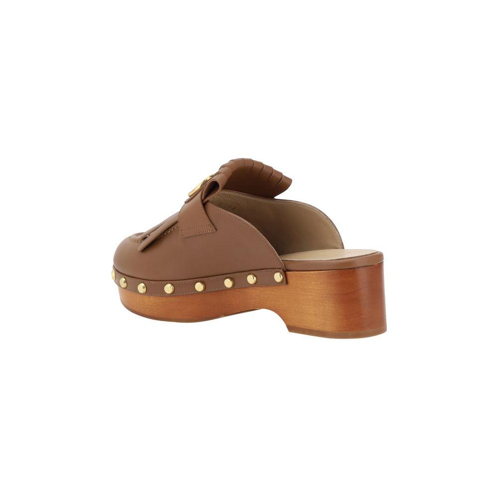 Valentino Garavani Leather MulesValentino Garavani’s leather sabot is an elegant reinterpretation of the clog, perfect for those seeking a mix of comfort and style. The model features a round toe that ensures a comfortable fit, while the iconic three-dime