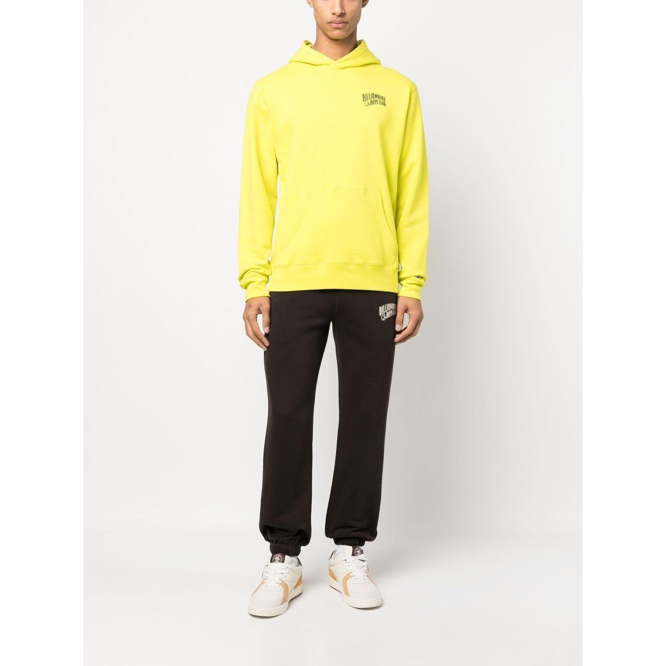 Model wearing Billionaire Sweaters Yellow with hood, logo print, embroidered sleeve, and front kangaroo pocket.