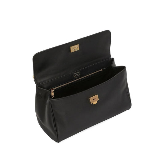 Black handbag with gold accents on a white background