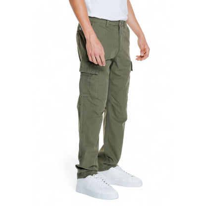 Man wearing Jack Jones Green Cotton Cargo Pants with side flap pockets and tapered fit.
