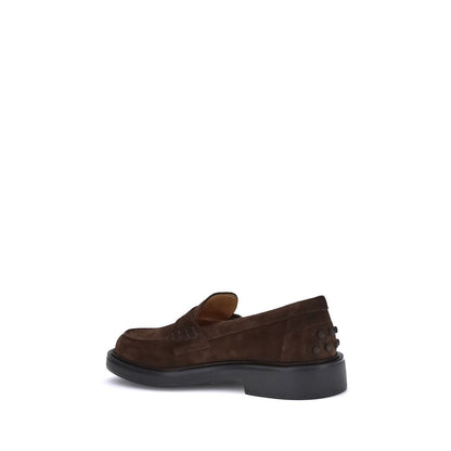 Side view of Tod's Brown Rubber Slip-On Loafers showcasing hand-stitched details and pebble heel for authentic and elegant style.