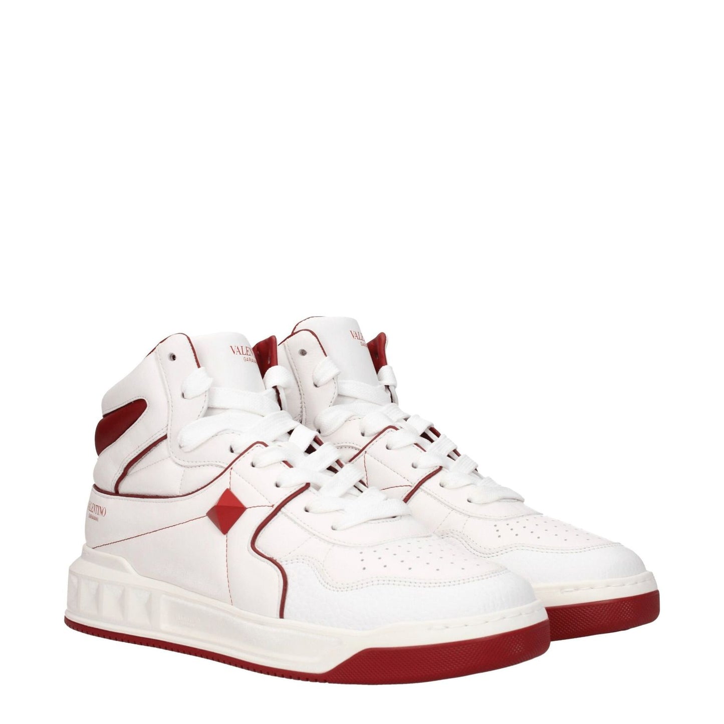 Valentino Garavani White Leather High Top Sneakers featuring studs, front and side logos, lace-up closure, mid heels, and red accents.