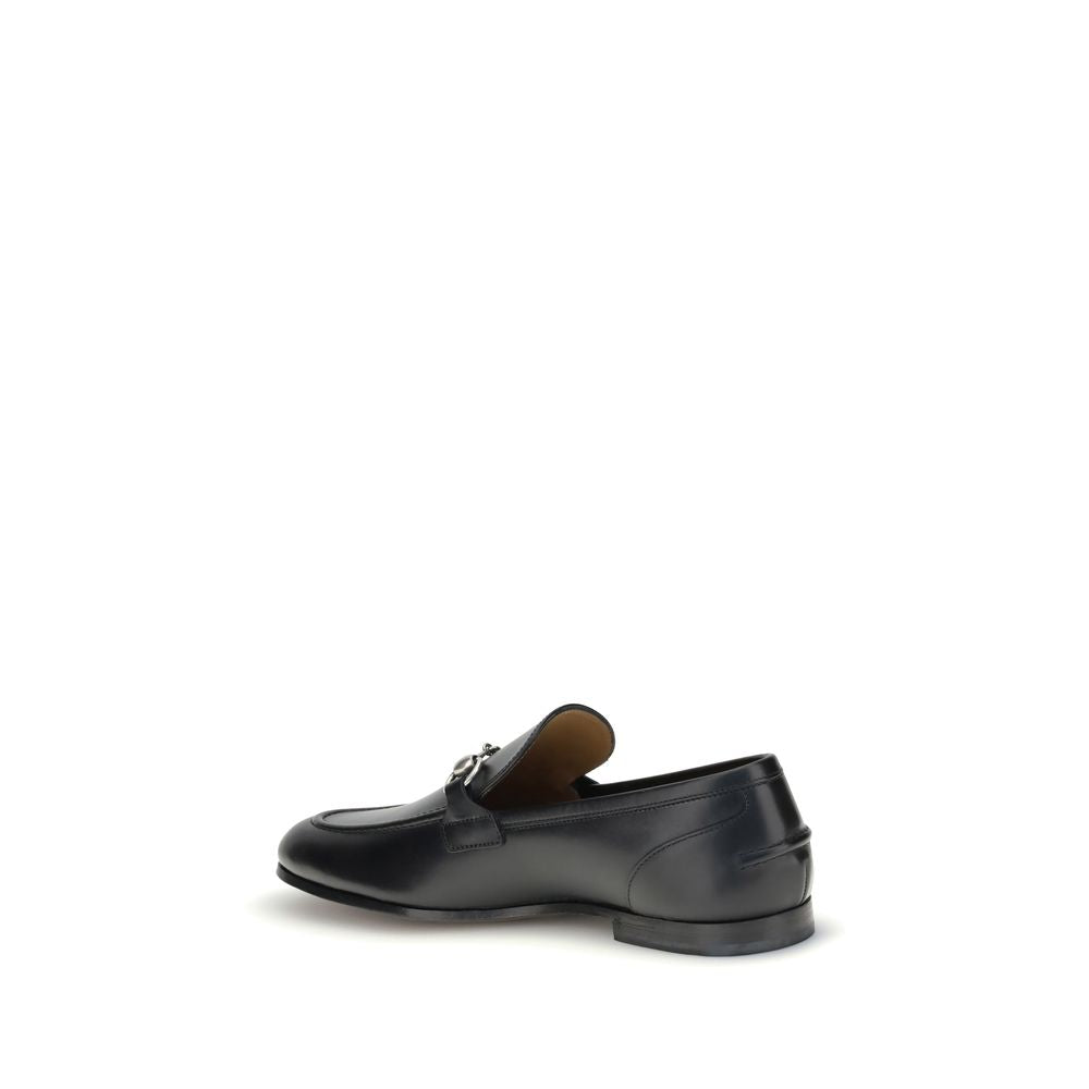 Gucci Black Calf Leather Bos Taurus Slip-On Loafers with Morsetto detail, elegant round toe, embossed logo, formal or casual shoe.
