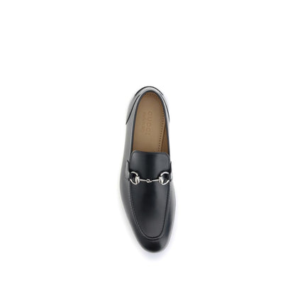 Top view of Gucci Black Calf Leather Bos Taurus Slip-On Loafers with metallic Morsetto detail, showcasing elegant craftsmanship.