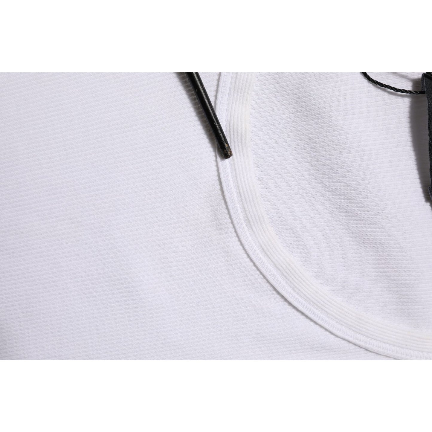 Close-up of Dolce & Gabbana White Sleeveless Round Neck Tank Top T-shirt neckline with tag, showing fabric details.
