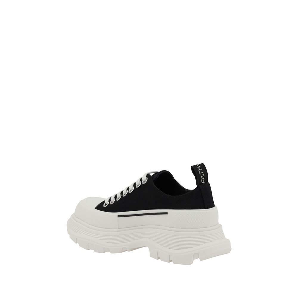 Alexander McQueen Black Rubber Chunky Sneakers with reinforced toe and lace-up closure. Modern design with platform sole and heel pull tab.