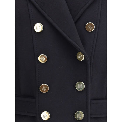 Close-up of Balmain Black Wool Coat with engraved gold buttons and broad lapels, showcasing iconic urban style and sophistication.