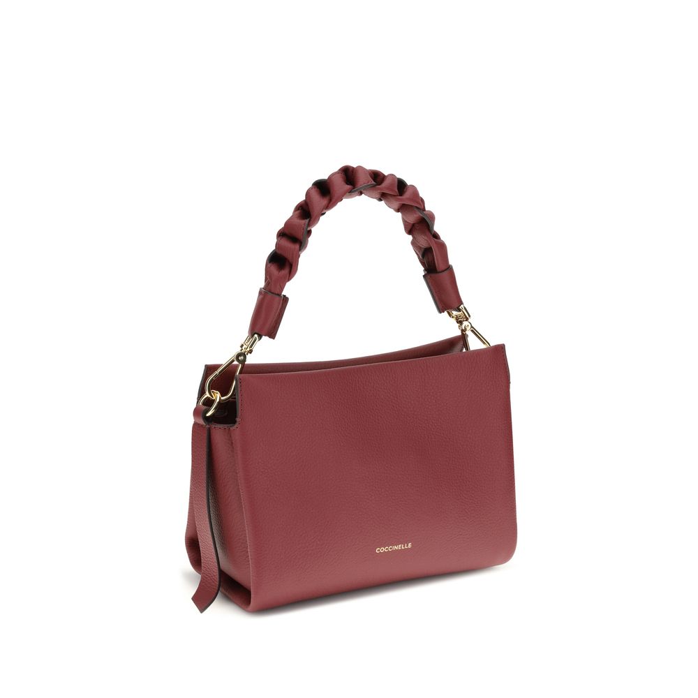 Coccinelle Bordeaux Calf Leather Bos Taurus Shoulder Bag with braided handle and adjustable strap on white background.
