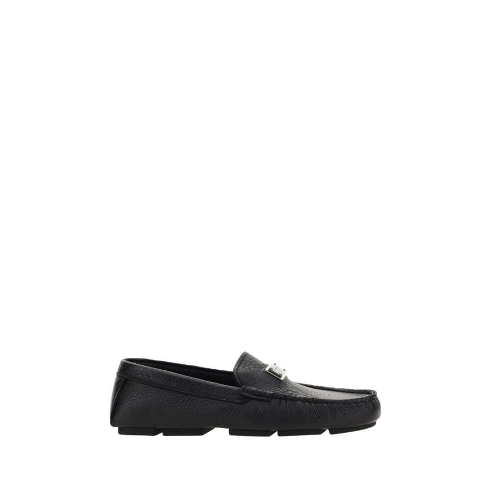 Dolce & Gabbana Black Rubber Slip-On Loafers with calfskin upper and metal monogram plaque on a non-slip flat sole.