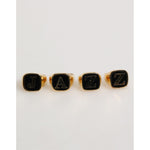 Dolce & Gabbana Gold Tone Brass JAZZ Letter Set 4 Pieces Adjustable Ring, featuring bold black letters on elegant gold-tone rings.