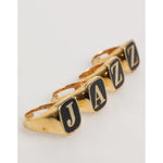 Dolce & Gabbana Gold Tone Brass JAZZ Letter Set 4 Pieces Adjustable Ring on white background.