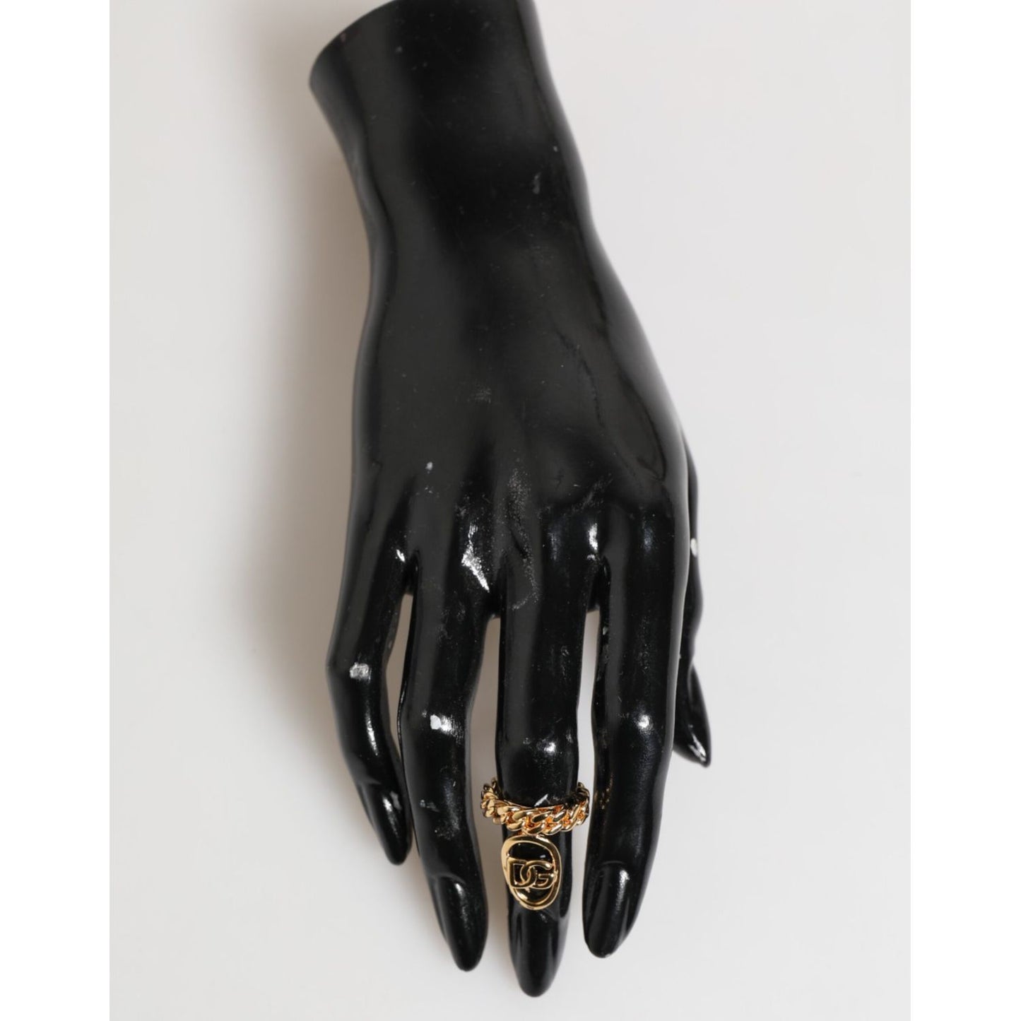 Dolce & Gabbana Gold Tone Brass Oval DG Logo Chain Adjustable Ring on black mannequin hand.
