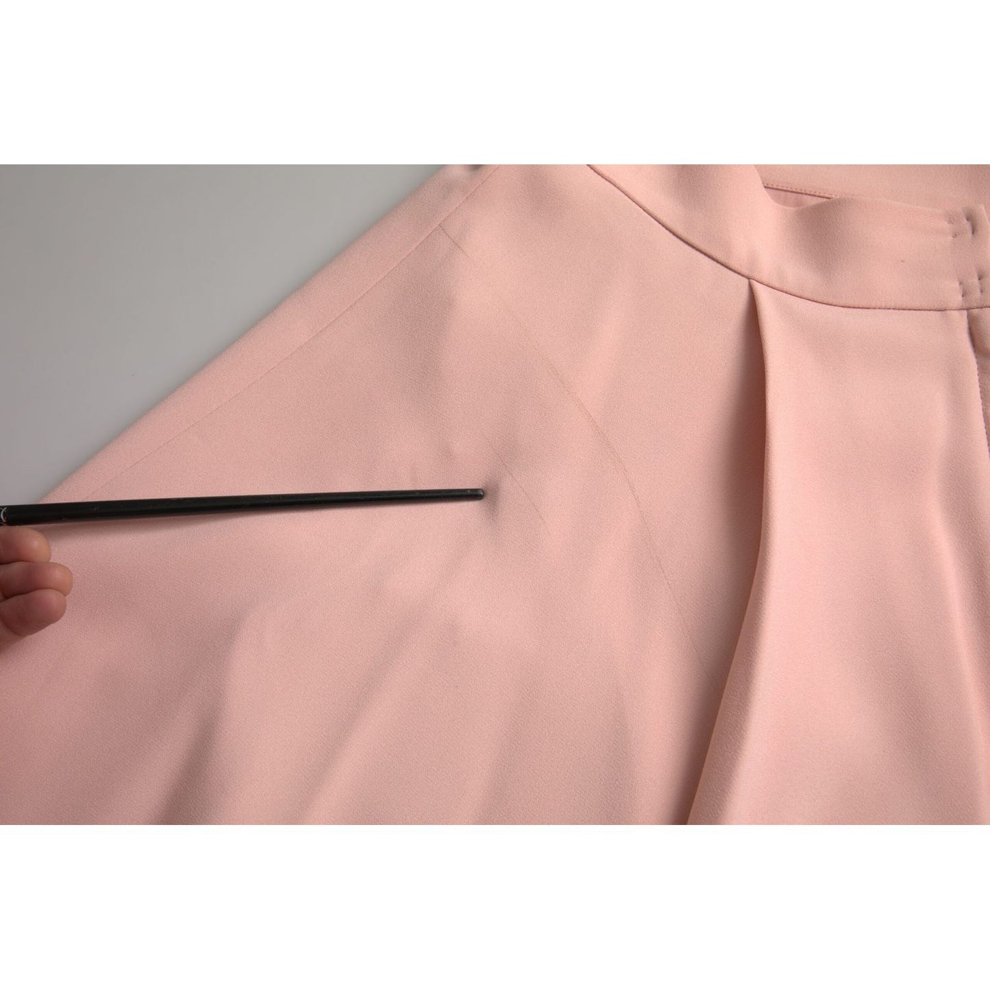 Close-up of Dolce & Gabbana Light Powder Rose Viscose Pleated Skirt showing fabric texture and pleats.