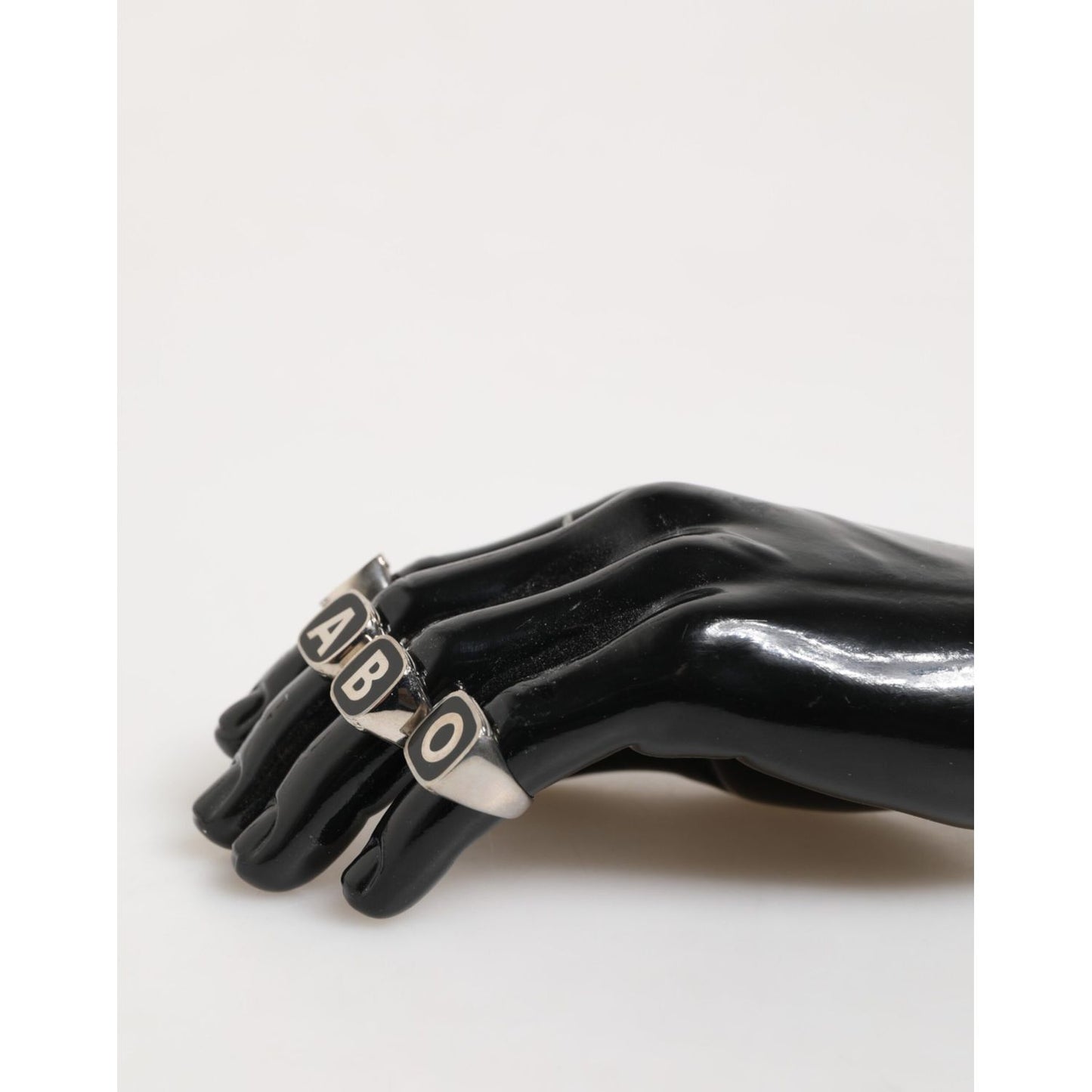 Dolce & Gabbana Silver Tone Brass Lettering Set 5 Pieces Adjustable Ring displayed on black mannequin hand.