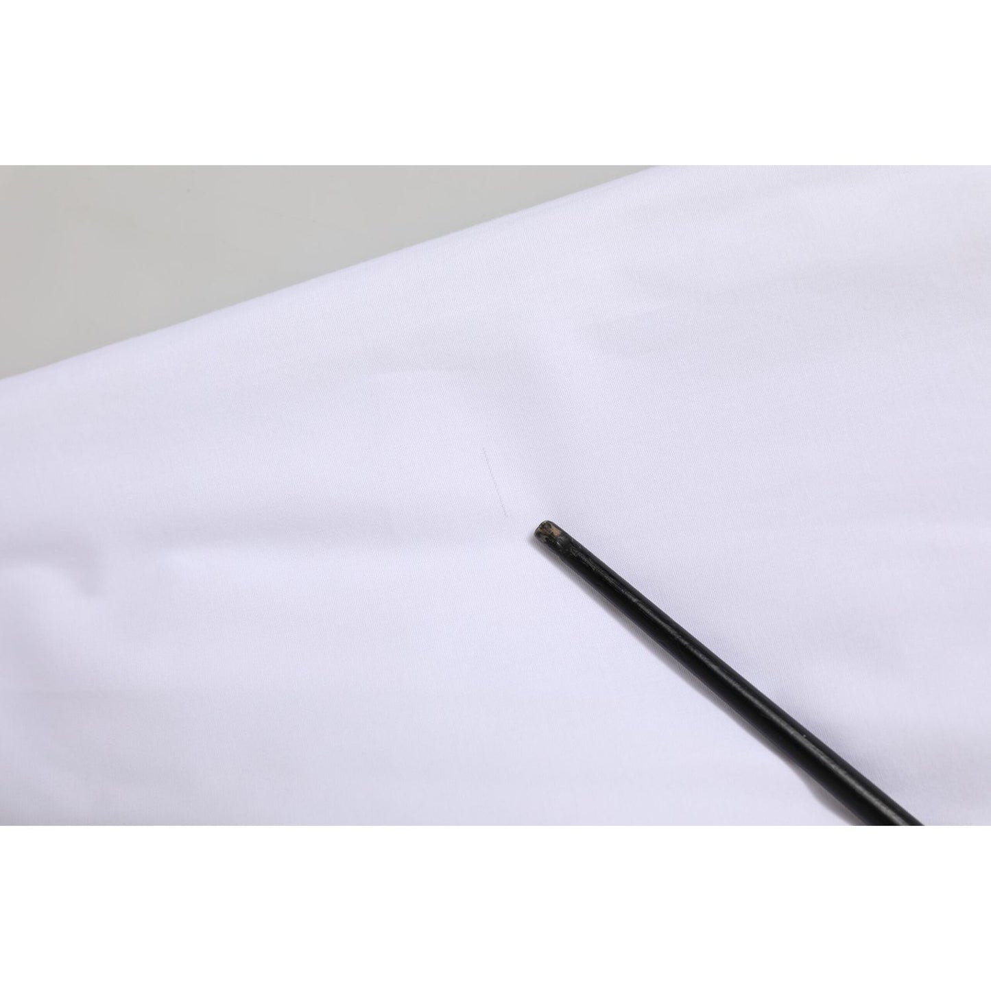 Close-up of Dolce & Gabbana White Cotton Collared Dress Formal Shirt Top fabric detail showing texture and finish.