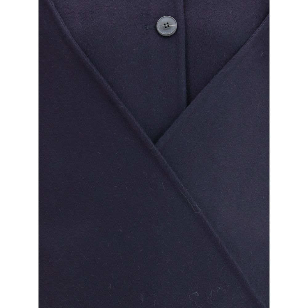 Close-up of Dynamis Studio Blue Wool Coat, highlighting button closure and fabric texture.