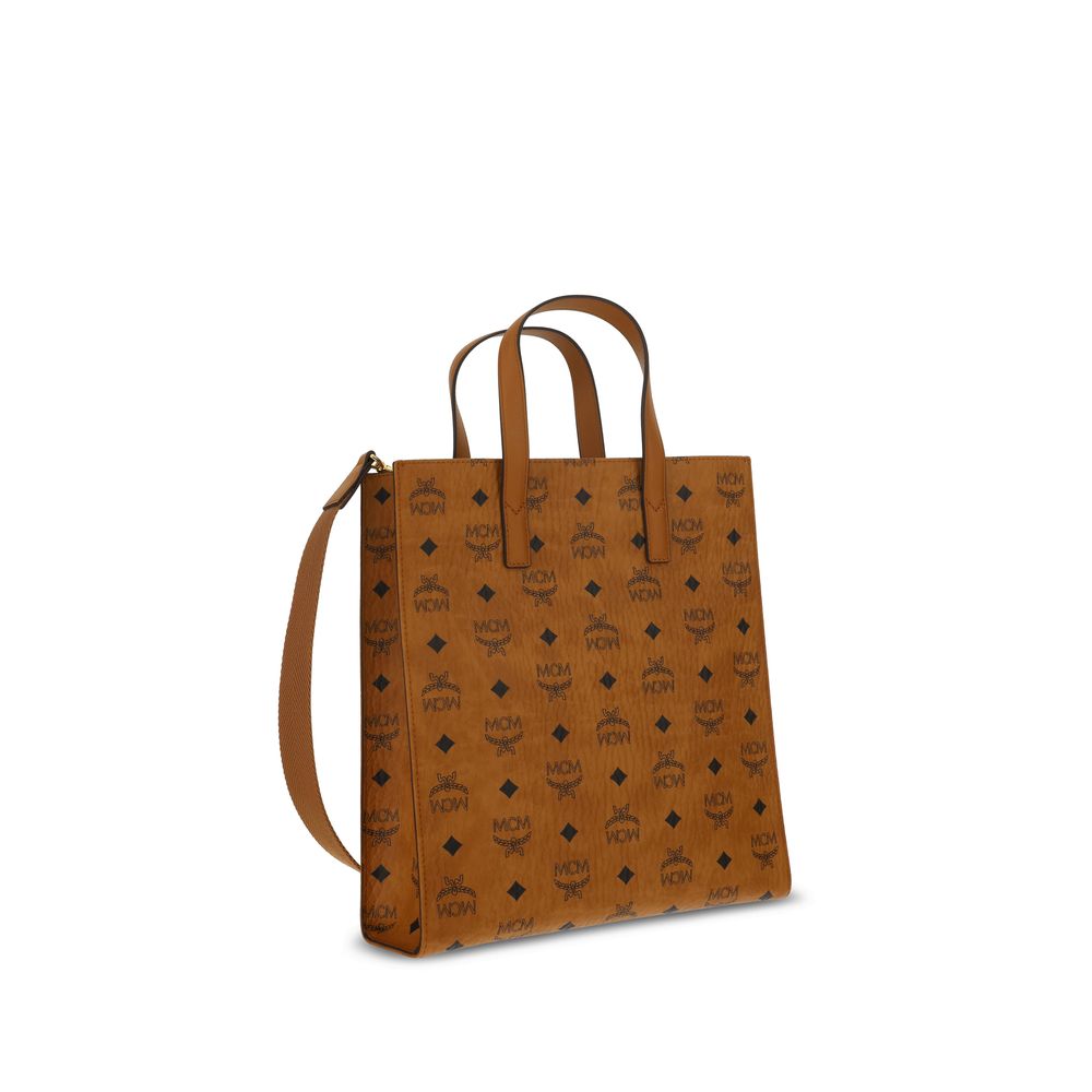MCM Brown Polyethylene Shoulder Bag with monogram pattern, rigid handle, and removable strap. Features embossed plaque and magnetic closure.