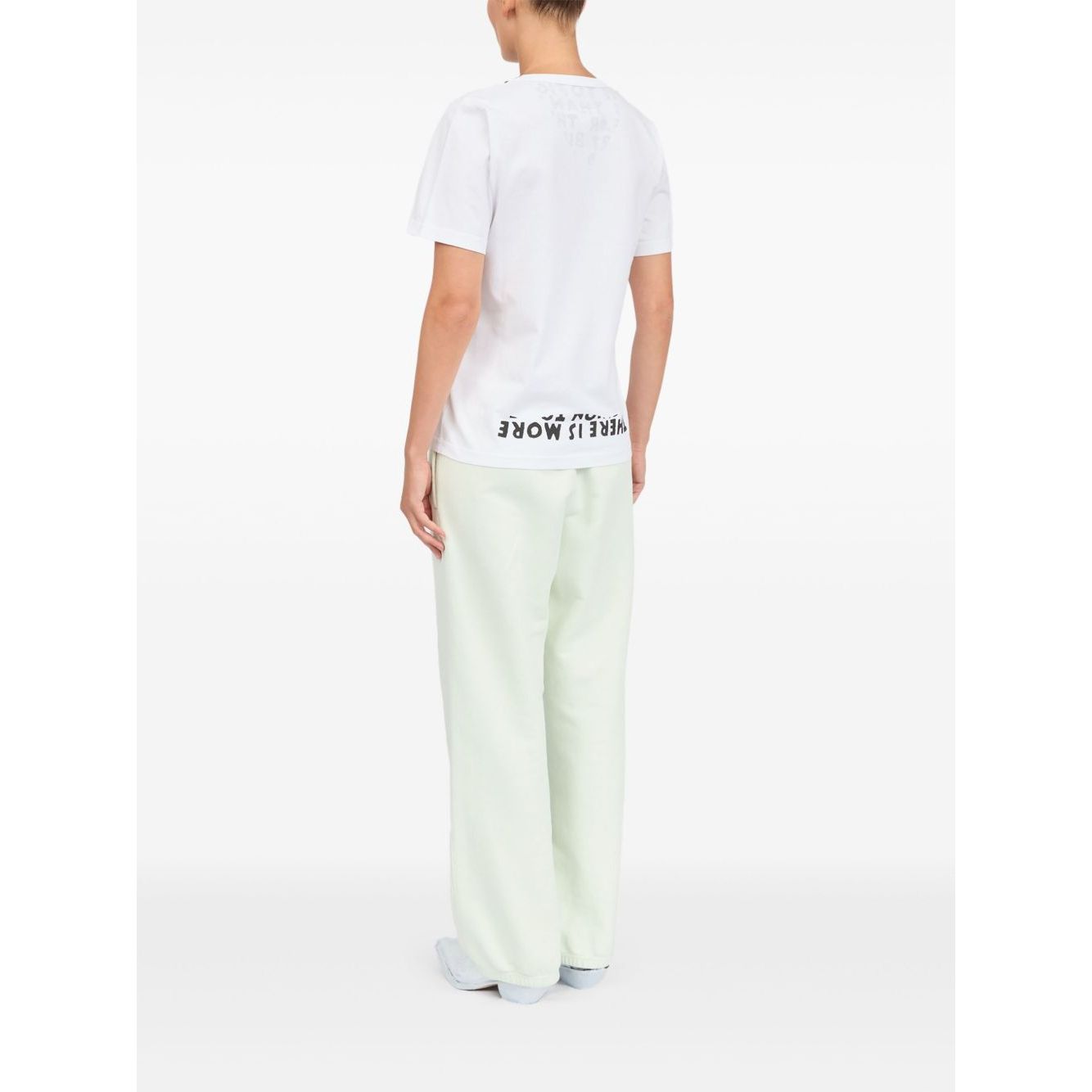 Back view of a person wearing MM6 Maison Margiela T-shirts and Polos White with a graphic print and V-neck design.