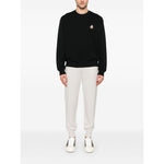Male model wearing Maison Kitsuné Maison Kitsune speedy fox patch comfort sweatshirt in black with ribbed cuffs and hem.