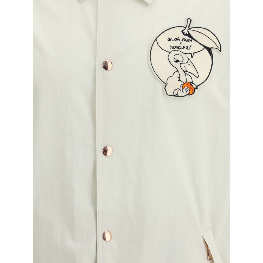 Moncler x Donald Glover White Cotton Coat featuring Gilga Farm comic-style patch and Moncler mascot embroidery.