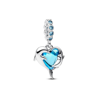 PANDORA Mod. 793924C01 silver heart charm with blue stone accents and dolphin design.