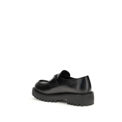 Side view of Prada Black Calf Leather Bos Taurus Slip-On Loafers with rubber sole showing craftsmanship and luxury design.