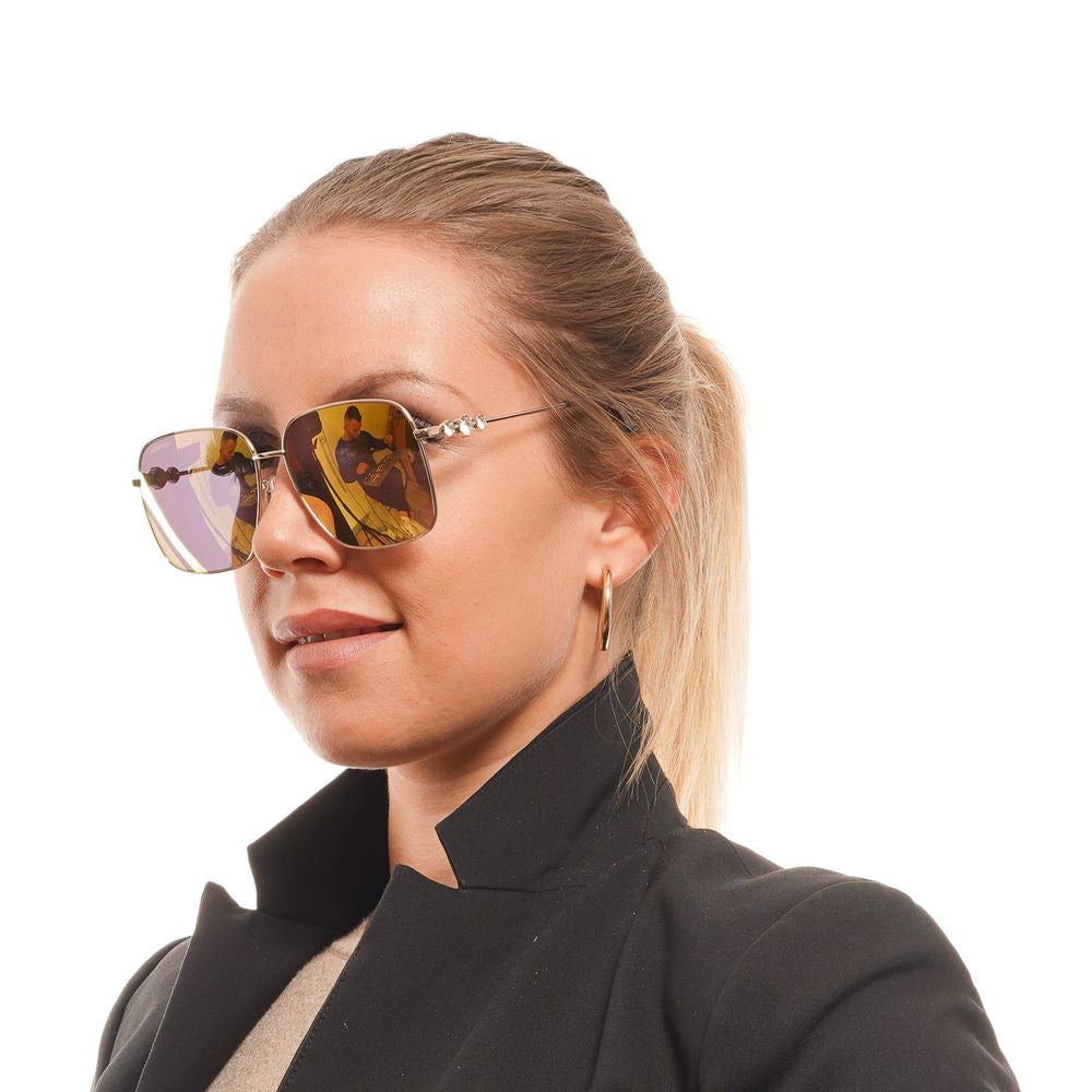 Swarovski Gold Women Sunglass with gold metal frame and mirrored brown lenses, featuring square style and full-rim design, worn by a woman.