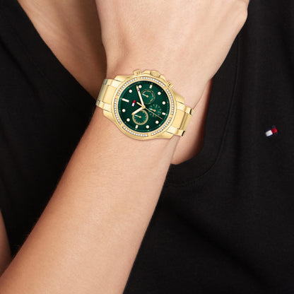 TOMMY HILFIGER Mod. 1782614 ladies quartz analog watch with gold bracelet, green dial, and 41mm case displayed on wrist.
