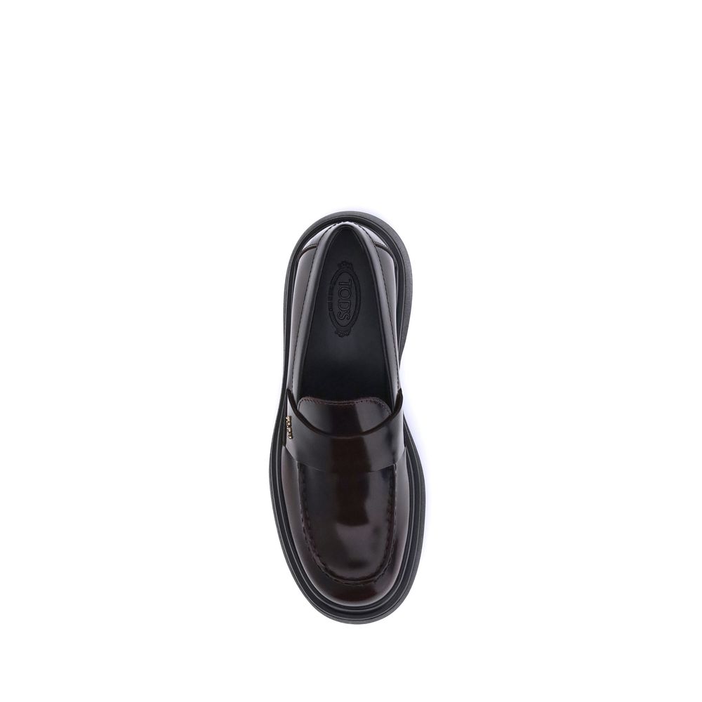 Top view of Tod's Brown Rubber Platform Loafers with patent leather and logo plaque detailing.