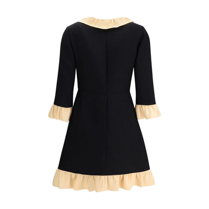 Back view of Valentino Black Fleece Wool Cocktail Dress with cream ruffle detail, featuring three-quarter sleeves and elegant design.