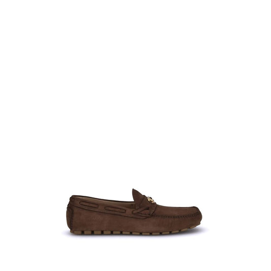 Valentino Garavani Brown Rubber Slip-On Loafers with VLogo plaque and notched sole for grip and comfort, side view.