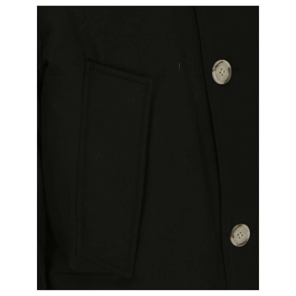 Woolrich Black Cotton Parka close-up showing button details and pocket.