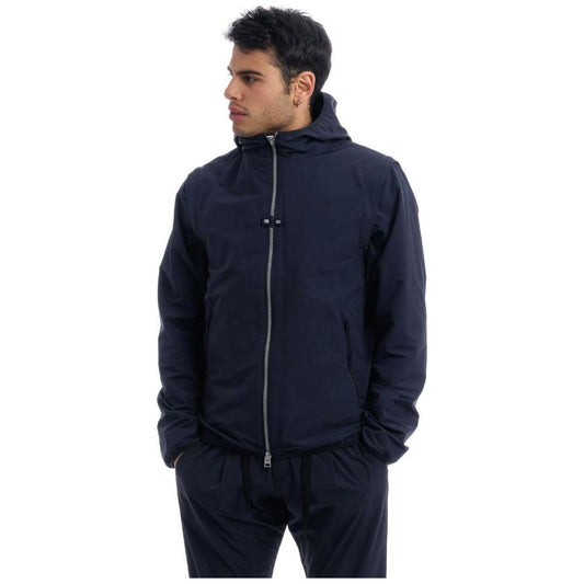 Herno blue nylon jacket with hood, removable sleeves, and side pockets modeled by a man.